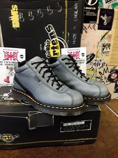 This original Made in England Dr Martens boot is not your usual style they produce, but they are very nice indeed. This is a 7 eyelet ankle boot that has been finished in a neutral blue leather that's very strong and good to wear in all weather's. It has the traditional trade mark yellow stitching and air cushioned sole unit with a BLACK leather strip art the back of the boot. It has potmark holes punched in to the leather on both feet, giving  it that more individual look. Lace-up Work Boots With Reinforced Heel For Streetwear, Steel Toe Lace-up Boots For Streetwear, Casual High-top Boots With Protective Metal Feet, Streetwear Steel Toe Ankle Martin Boots, Casual Steel Toe Lace-up Boots For Streetwear, Ankle-high Boots With Reinforced Toe For Streetwear, Low-top Steel Toe Boots For Streetwear, Blue Leather Boots With Reinforced Toe, Steel Toe Ankle-high Boots For Streetwear