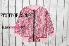 a pink and black jacket with the words front of jacket on it, against a white wooden background