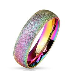 A sparkly sand finish wedding band style ring in Rainbow Ion Plated stainless steel. The sparkle finish add beautiful accents to the ring. Sized for men and women. Perfect for couples.  Beautiful ring in 316L stainless steel. Perfect for casual wear or that special occasion. Comfort Fit, semi-domed inside the ring for comfort. Width: 6mm Ring Size: Available in Size 5-13 Weight: approx. 4.9 grams depending on the size of the ring Spiked Jewelry, Unicorn Ring, Partner Rings, Glitter Ring, Metallic Rainbow, Rainbow Ring, Wedding Band Styles, Ring Rosegold, Mens Rings