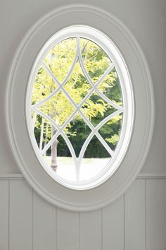 a round window in the wall with white paint