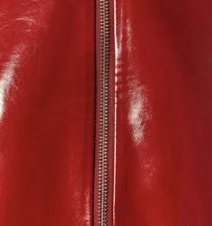 a close up view of the zippers on a red leather jacket