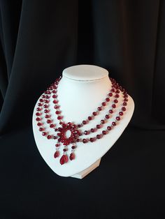 This is a round choker of pretty faceted beads in a multi-shaded deep ruby red, that are fashioned into a Victorian / Edwardian style choker necklace. And being quality glass beads, there's a nice weighty feel to the choker! - you may be able to find other cheaper chokers, but please check the material they are made from (usually plastic!) MEASUREMENTS The necklace is adjustable, so it can be worn on any size neck from approx 13 inches to 15.25 inches round. Necklace Blood, Burgundy Jewelry, Victorian Chandelier, Victorian Choker, Chandelier Necklace, Gothic Choker, Blood Drop, Gothic Chokers, Romantic Necklace