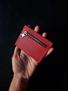 A tiny red Buttero Hatch leather wallet that will easily fit in most pockets. Crafted from red Buttero Hatch leather, this tiny accessory showcases a small coin pouch and slot for a card or two. It can also be used for some cash - an ideal variant for minimalists seeking to carry as little as possible. What is Butter Hatch leather? It is vegetable tanned leather produced by one of the most famous tanneries in the world called Walpier. The leather is prized for its quality and authentic look. It Red Leather Card Holder With Interior Slots, Red Leather Card Holder For Daily Use, Red Leather Coin Purse With Card Slots, Red Leather Everyday Card Holder, Red Leather Card Holder With Coin Pocket, Red Leather Wallet With Card Slots, Modern Red Everyday Wallet, Red Leather Coin Purse With Interior Card Slots, Red Leather Coin Purse With Rfid Blocking