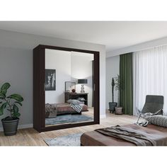 a large mirror in the middle of a room with a chair and potted plant