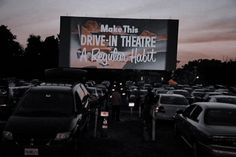 an outdoor drive - in theatre with cars parked on the lot