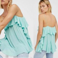 A Voluminous Intimately By Free People Cami With Cascading Ruffles In A Dreamy Seafoam Green Color. Swingy Relaxed Fit, I Would Say This Runs A Little Large. Features A Square Neckline With Spaghetti Straps. Popover Style With A Slight High Low Hem. A Little Sheer, Girly And Flirty With Amazing Movement! Beautiful Blue Green Color. This Top Is New Without Tags But Came In With A Very Small Spot On The Back Ruffle. See Photo. Measures 15" Flat Pit To Pit; 26" Strap To Hem (Approximately) Flowy Summer Tops With Ruffled Straps, Trendy Blue Flowy Top, Blue Trendy Loose Fit Tops, Trendy Ruffled Tops For Summer, Blue Ruffle Tops For Summer, Blue Ruffled Tops For Summer, Feminine Blue Ruffled Tops, Summer Blue Ruffled Blouse, Light Blue Feminine Ruffle Tops