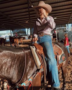 a man sitting on the back of a brown horse