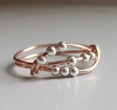 Rose gold-filled fidget ring with 9 tiny sterling silver beads that move around. The beads are only 2 mm. If you would like a different amount of beads, just leave a note at checkout. You can also message me for a custom order. ~Listing is for one ring. *Each ring is made to order, and they are all made by hand, so please allow for slight variations. *When ordering, order your regular size. I adjust for the beads. *If you don't see your size, please message me. I can make these in any size. *All Bijoux Fil Aluminium, Ring Wire, Wire Wrapped Ring, Fidget Rings, Silver Spinner Rings, Wire Rings, Ring Rose Gold, Wire Wrapped Rings, Handmade Rings