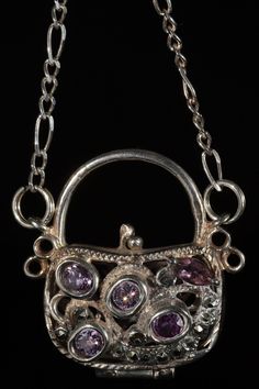 "This is a beautiful vintage sterling silver chain and purse pendant with amethyst stones. The purse is marked \"925\" on the handle. The purse does not open easily which prevents it from opening unexpectedly. The 24 inch Figaro chain is also sterling silver. It is marked \"925\" and \"Italy\" near the clasp. This chain and pendant are are in good vintage condition with normal surface wear. Please review all of the photographs and if you have any questions message me. Approximate Measurements: P Silver Purse, Chain And Pendant, Amethyst Stones, Vintage Jewelry Necklace, Figaro Chain, Necklace Sterling Silver, Amethyst Stone, Sterling Silver Chain, Vintage Necklace