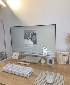 a computer monitor sitting on top of a wooden desk next to a keyboard and mouse