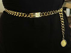 Classic and chic, this vintage Chanel chain belt is crafted in gold-plated metal, accented with a 'CC' logo-engraved medallion pendant. Closure can be hooked on multiple links for a variety of fits.Brooch Specifications:Designer: CHANELFits Waist Size Up To: 31"Coin Measurements: ~1.25" Stamped: "CHANEL "Made in France"Condition: PreownedGold Plated Chanel Waist Chain, Vintage Chanel Belt, Luxury Metal Chain Belt, Chic Gold-tone Metal Chain Belt, Belt Chanel, Luxury Elegant Gold-tone Chain Belt, Chanel Chain Belt, Chanel Chain Belt Vintage, Luxury Chain Belt With Gold-tone Hardware