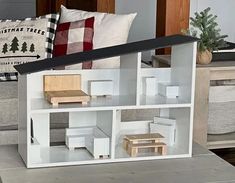 a doll house made out of white cardboard