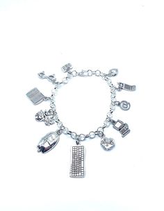 "New. This Bracelet makes a perfect gift  has 12 Computer Tech IT  themed Charms.  Stainless Steel bracelet has a lobster clasp closure measures approx 8\" bracelet and charms are silver tone alloy and steel. Charms measure approx 1/2\" - 1\" in size charms include Book, Glasses, Laptop, Bugs, Mouse, Keyboard, Cookie, Computer, @ symbol, Cell phone, Small Puffy Heart" Novelty Silver Charm Bracelet Gift, Silver Novelty Charm Bracelet As A Gift, Silver Novelty Charm Bracelet Gift, Novelty Silver Metal Charm Bracelet, Silver Novelty Charm Bracelet, Silver Novelty Metal Charm Bracelet, Novelty Silver Hypoallergenic Charm Bracelet, Silver Novelty Bracelets With Charms, Silver Metal Novelty Bracelets