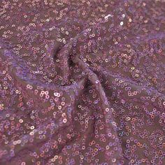 A swirled sample of zsa spa spandex sequin in the color mauve-light pink. Holographic Sequins, Chocolate Roses, Border Print, Sequin Fabric, Blue Moon, Cotton Lights, Color Card, Athletic Wear, Fabric Store