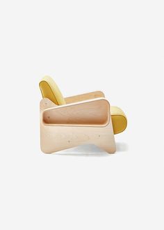 a wooden chair with a banana shaped seat on it's back and foot rest