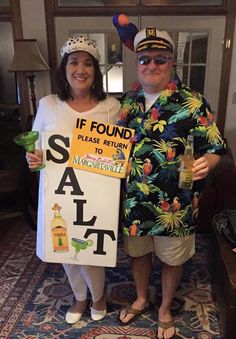 a man and woman in costumes holding signs that read if found please return to margaritaville