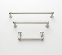 two stainless steel towel bars on a white wall