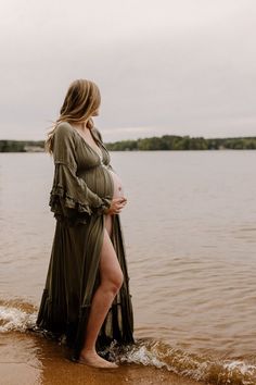 a pregnant woman is standing in the water