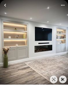 a living room filled with furniture and a flat screen tv mounted on a wall above a fireplace