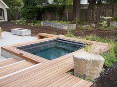 an outdoor hot tub surrounded by wooden decking