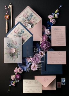 the wedding stationery is laid out on top of each other