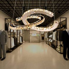 a man standing in front of a chandelier with lights hanging from it's ceiling