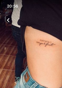 a woman with a tattoo on her stomach that says happily happy life in cursive writing