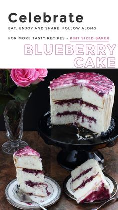 a cake with white frosting and raspberry toppings on a black plate