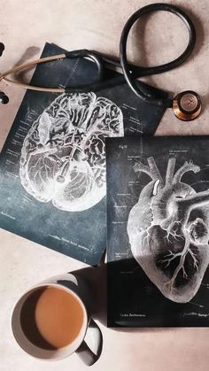 two pictures of the human heart on paper next to a cup of coffee