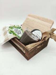 a wooden box with a coffee cup and tea bag in it