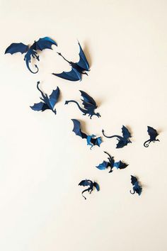 a group of blue paper bats flying through the air