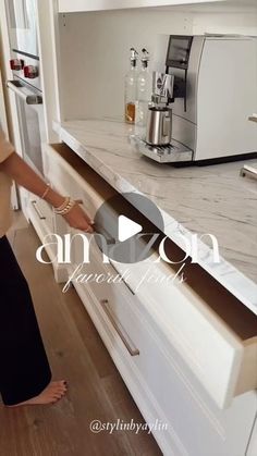 a woman standing at the edge of a kitchen counter