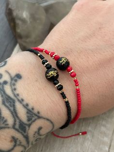 Dainty beaded Chinese Dragon bracelets, they are size adjustable and are available in black and red as shown in the pictures. This could be perfect matching or friendship bracelets, but also a unique layering bracelet to add to your collection. A most have addition to your everyday bracelets. ⚡️GET 20% OFF NOW⚡️ JOIN AKASHI'S VIP LIST and Shop ⚡️Join Akashi's VIP list for early bird discount access⚡️ Paste into your browser http://eepurl.com/hgCMM1 and follow the simple steps. ⚡️To see more unique jewelry, click the link below👇 https://www.etsy.com/shop/AkashiJewelry?ref=seller-platform-mcnav Enjoy Con salud Adjustable Black Beaded Friendship Bracelets, Black Round Beads Friendship Bracelets With Adjustable Length, Black Friendship Bracelets With Adjustable Round Beads, Black Friendship Bracelets With Colorful Beads As Gift, Adjustable Black Friendship Bracelets With Tiny Beads, Adjustable Black Friendship Bracelet With Colorful Beads, Black Resizable Bracelets With Round Beads, Black Adjustable Length Round Beads Friendship Bracelets, Adjustable Black Hand-strung Friendship Bracelets