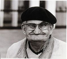 an old man wearing glasses and a hat