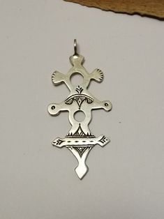 Typical and traditional Berber Tuareg solid sterling silver amulet. Featuring traditional Tuareg geometry representing the Tuareg tent, shifting desert sands and animal track motifs. Made in the cross shape to mimic the compass points and aid desert navigation with the night sky. Worn externally on the clothing (turban or necklace) as practical decoration. Silver stamped: Hallmark Weight: 5.8  grams Shipping : DHL EXPRESS 🙂 Traditional Cross Pendant For Ceremonial Occasions, Ceremonial Silver Cross Jewelry, Silver Cross Jewelry For Ceremonial Occasions, Traditional Silver Cross Pendant Jewelry, Traditional Ankh Silver Jewelry, Traditional Silver Ankh Jewelry, Cross Shape, The Compass, Statement Ring Silver