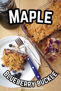 a blueberry crumb cake on a plate with a fork and knife next to it