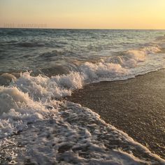 the sun is setting over the ocean waves