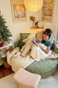 a person sitting on a bean bag chair reading a book