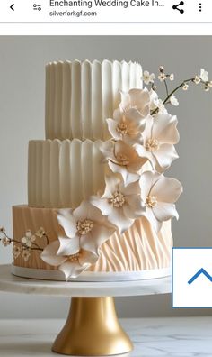 a wedding cake with white flowers on top