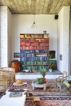 a living room filled with furniture and lots of books