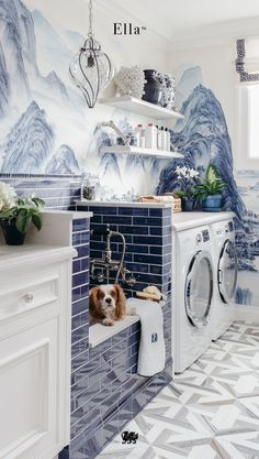 a laundry room with blue and white wallpaper, a washer and dryer