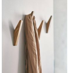 three pieces of wood are hanging on the wall