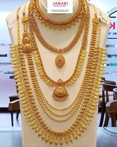 gold necklaces are displayed on display in a store