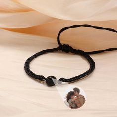 This is a mysterious bracelets, Personalized for the moment you love most on a projection bracelets! Engraved love never fades, and treasured memory will always be with you. Carry your Little cute photo hidden in the pendant, You can see the photo inside the pendant, or you can use it to illuminate the light and project your photo on the wall. The best dreamy gift for yourself and family, and friends. Customize Your Picture Projection Bracelets You can freely customize anything you like, including people, pets, scenery, and even symbol, and attach text as a souvenir. Please try to upload photos with high resolution, the higher the resolution, the more obvious the product effect. Meaningful Accessory & Memorial Gift This customized projection bracelets engraved with your favorite photo will Adjustable Black Promise Bracelet, Adjustable Black Bracelet For Promise, Black Adjustable Promise Bracelet, Couples' Black Promise Bracelets, Black Personalized Jewelry For Keepsake, Personalized Black Jewelry For Keepsake, Personalized Black Keepsake Jewelry, Black Couples Bracelet Jewelry, Couples' Black Braided Bracelets As Gift