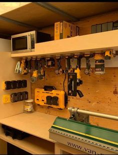 a workbench with tools and other equipment on it's shelves in a workshop