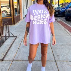 a woman standing on the sidewalk wearing a t - shirt that says your design here