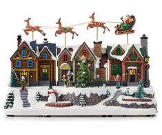 a christmas village with santa's sleigh and reindeers