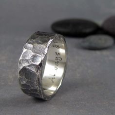 a wedding ring with an engraved design on it