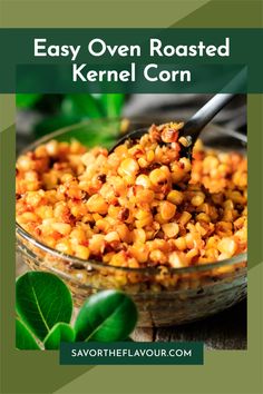 a bowl filled with cooked kernels on top of a wooden table next to green leaves