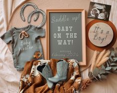 baby items are laid out on a bed with the names of their babies and pictures